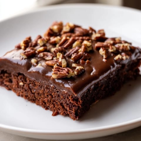 A moist slice of Texas sheet cake, a classic chocolate dessert, ready to be enjoyed.