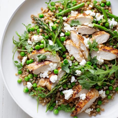 Bright spring vegetables and crumbled feta garnish this wholesome Warm Spring Farro Chicken Salad.  