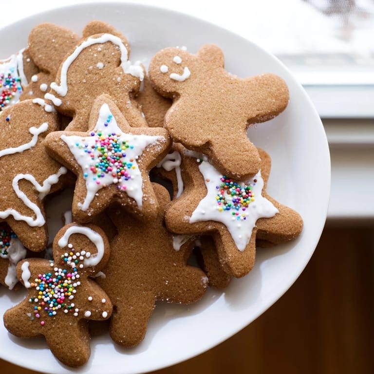 Freshly baked gingerbread cookies, awaiting colorful icing and sprinkles for holiday fun.