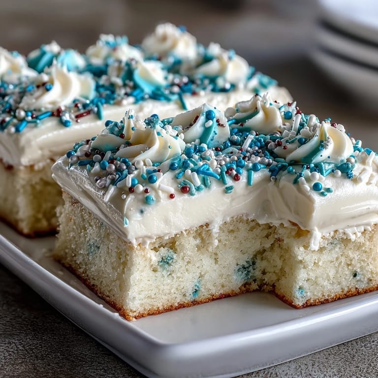 Festive vanilla sheet cake decorated with buttercream and graduation-themed sprinkles, ideal for parties.