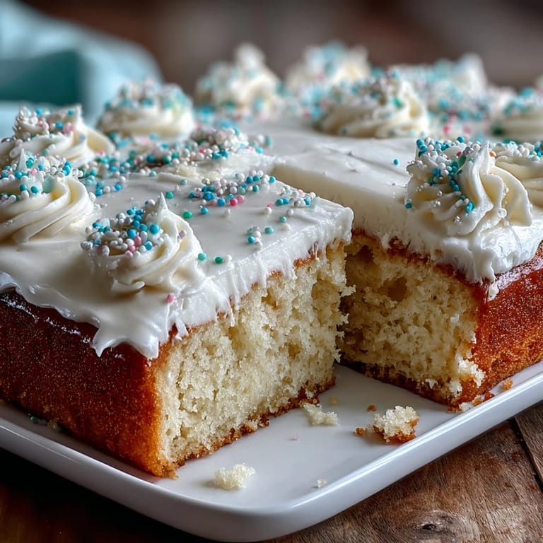 Classic vanilla sheet cake topped with smooth vanilla buttercream, decorated for a joyful graduation event.