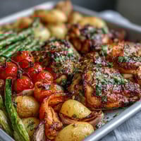 A colorful sheet pan dinner with juicy chicken and vibrant spring vegetables roasted to perfection.  
