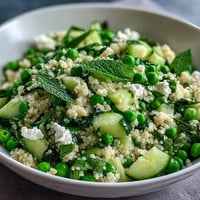 Spring Pea and Mint Couscous Salad with fresh peas, herbs, and lemon dressing, perfect for a light vegetarian side dish.
