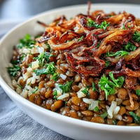 Levantine Mujadara piled high with fluffy rice, tender lentils, and golden crispy onions.