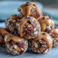 Golden peanut butter oat balls sit neatly arranged, a perfect no-bake energy snack.